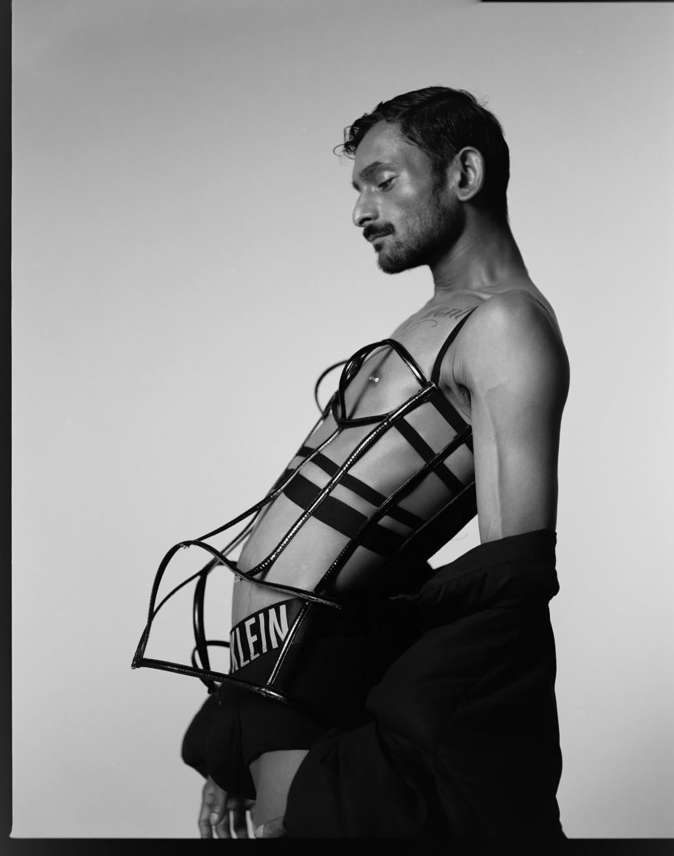 man in corset black and white