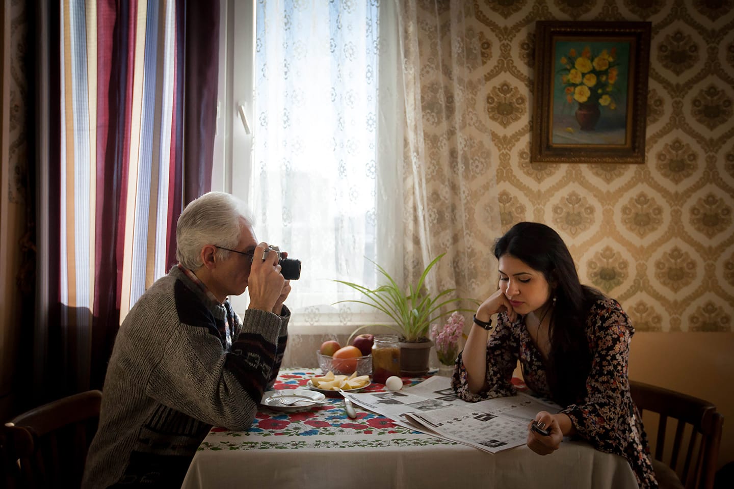 Father taking photo of Diana Markosian at a table