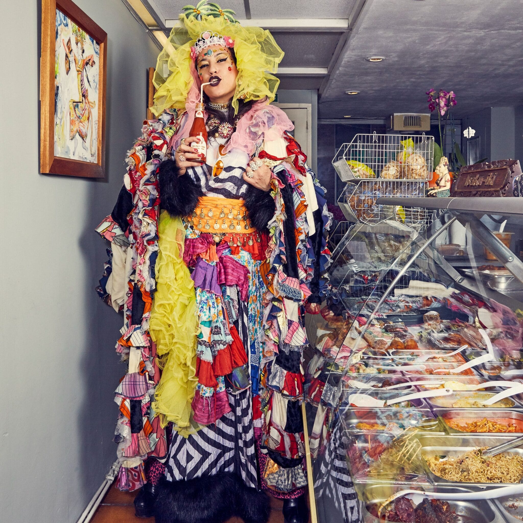 woman drinking ketchup in colourful outfit