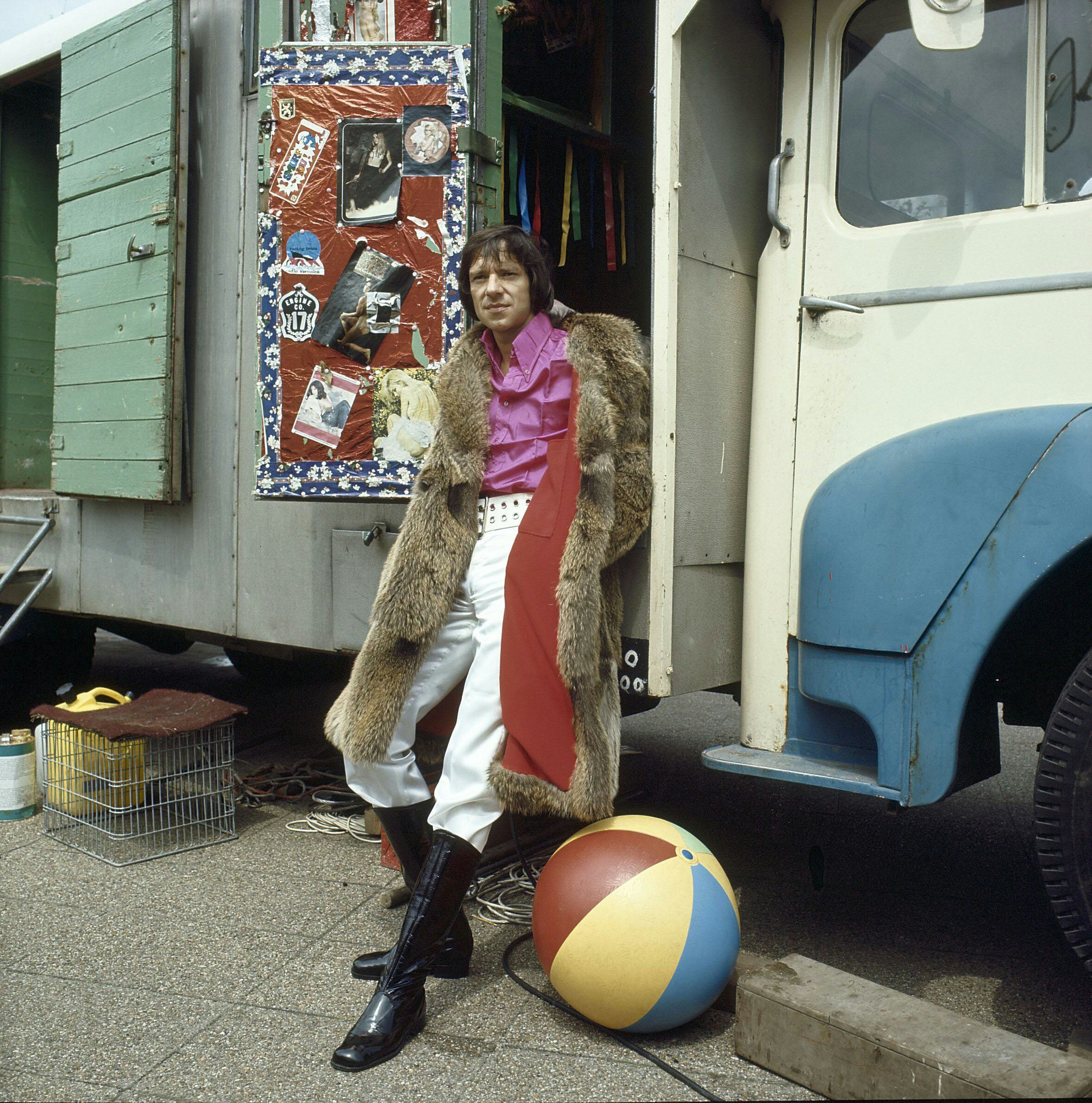 Ramses Shaffy poses in front of a truck