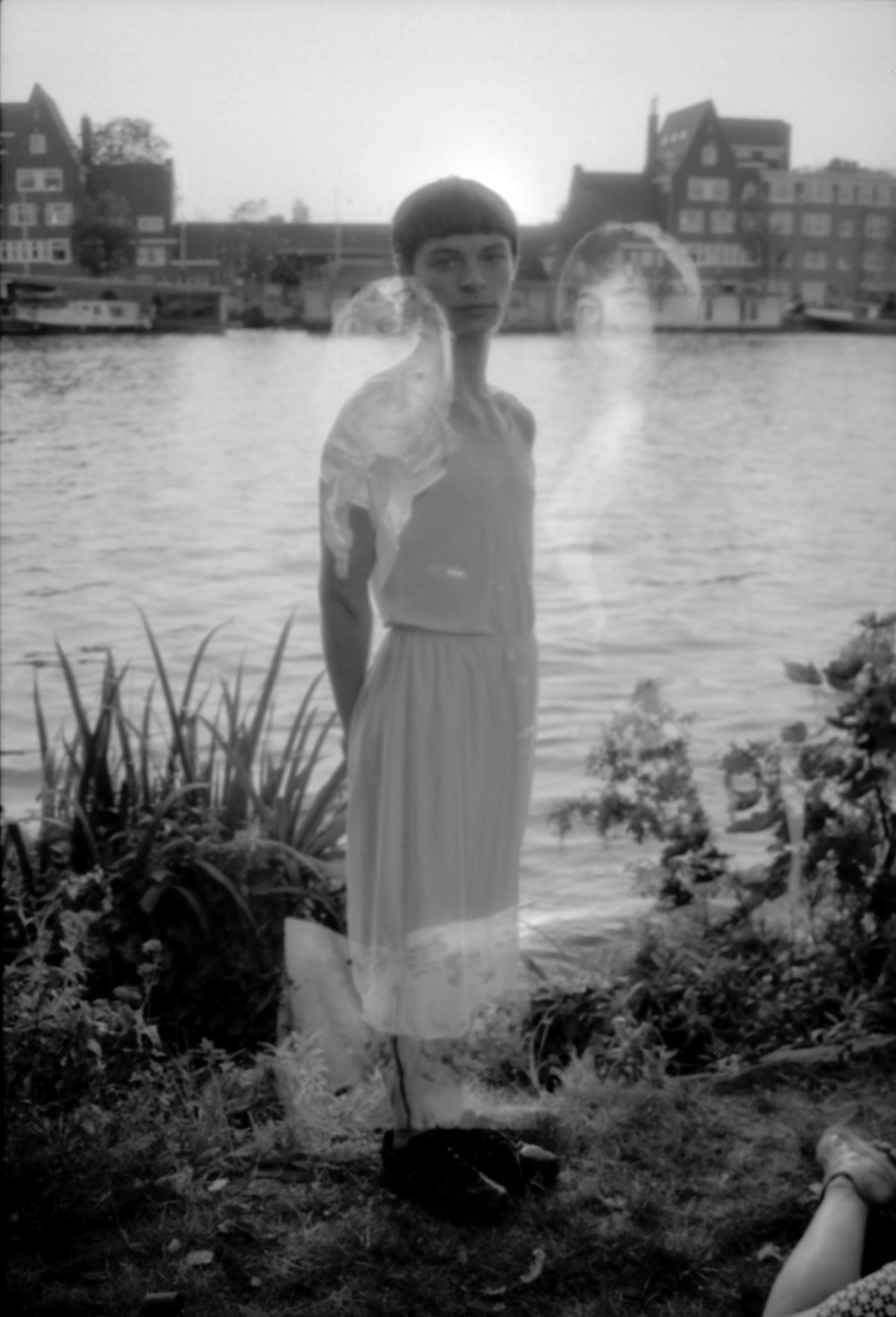 Woman standing by a lake