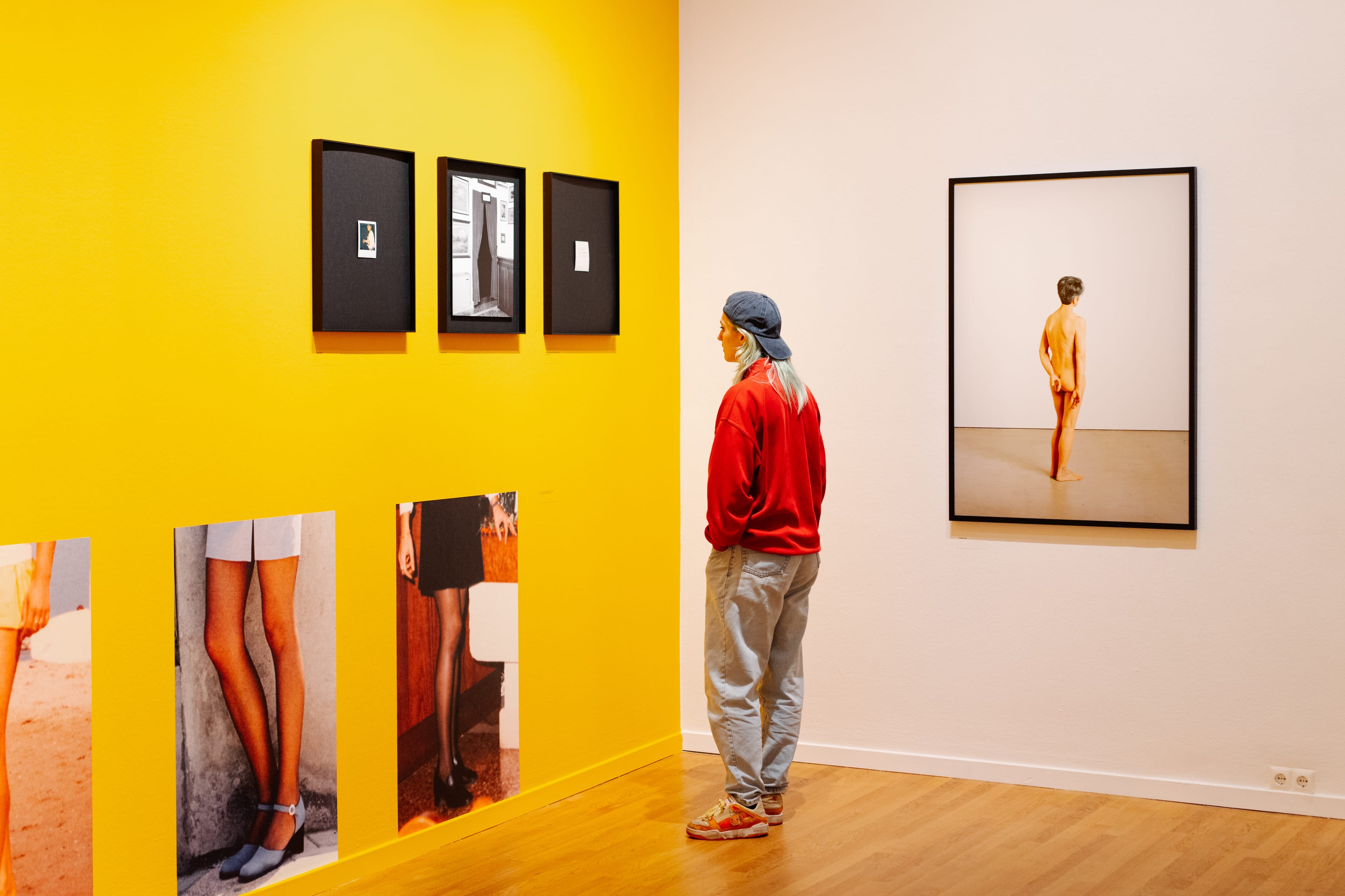 young woman viewing photography exhibition.