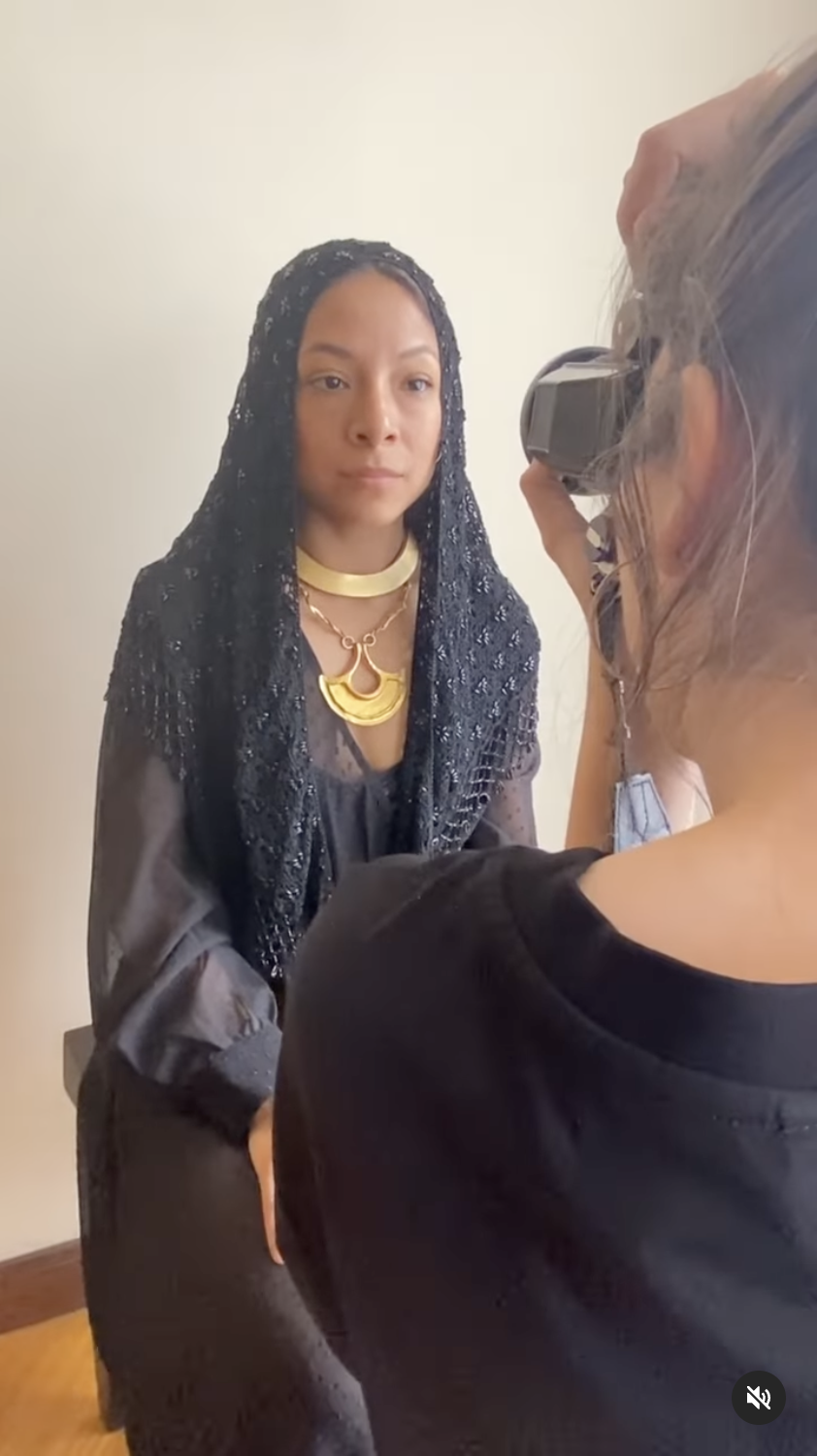 Screenshot of the One-Minute Workshop based on the work of Foam Talent 2024-2025 Marisol Mendez. Photo shows the model wearing a black veil and part of the photographer, taking her portrait.